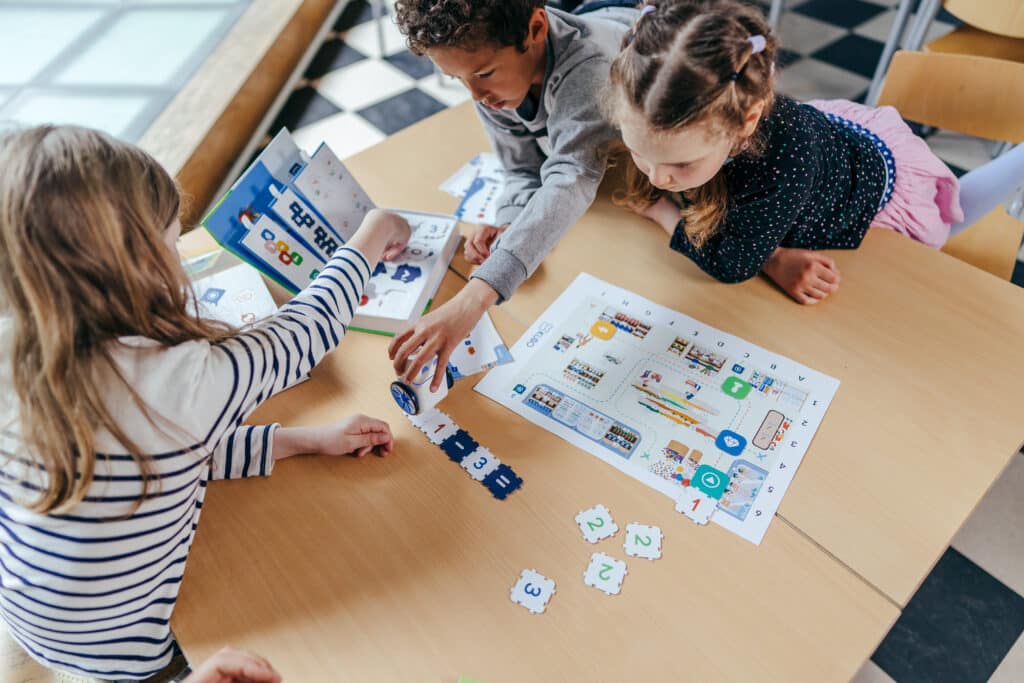 Three students coding together with KUBO on the store map