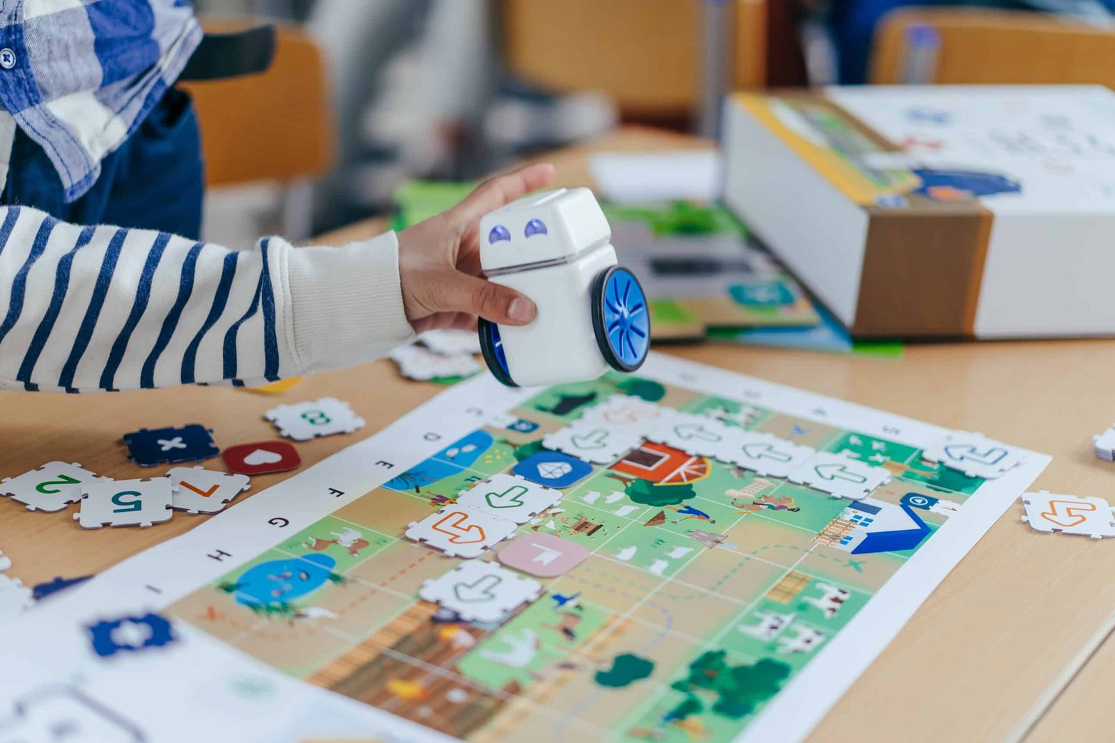 A student placing KUBO on a row of TagTiles on the activity map